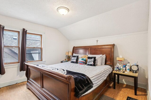 3025 W Pierce St, Milwaukee, WI 53215 - bedroom with baseboards, vaulted ceiling, and a textured ceiling