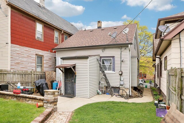 3025 W Pierce St, Milwaukee, WI 53215 - back of house with fence, a patio, a chimney, and a yard