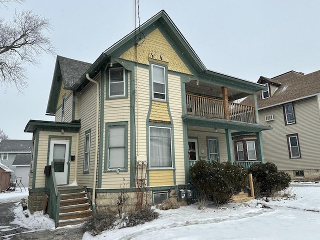 view of front facade featuring a balcony and entry steps