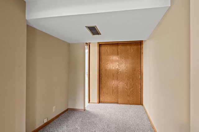 unfurnished bedroom featuring carpet flooring, a closet, visible vents, and baseboards