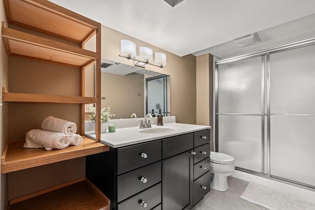 bathroom featuring toilet, tile patterned floors, vanity, and a shower stall