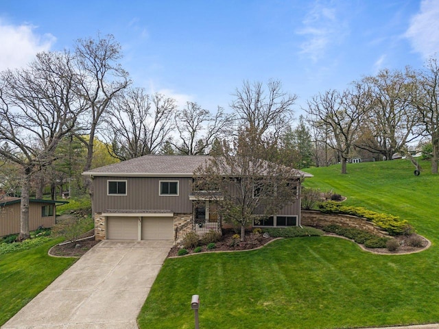 bi-level home featuring an attached garage, a front lawn, stone siding, and driveway