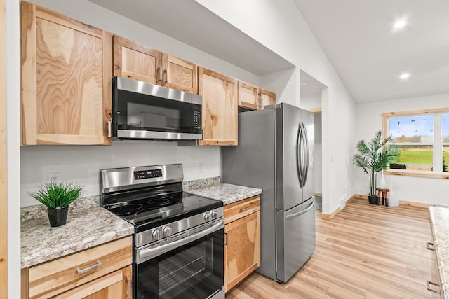 kitchen with light stone countertops, light wood-style floors, light brown cabinets, stainless steel appliances, and recessed lighting