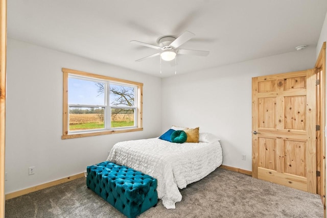 bedroom featuring baseboards, ceiling fan, and carpet