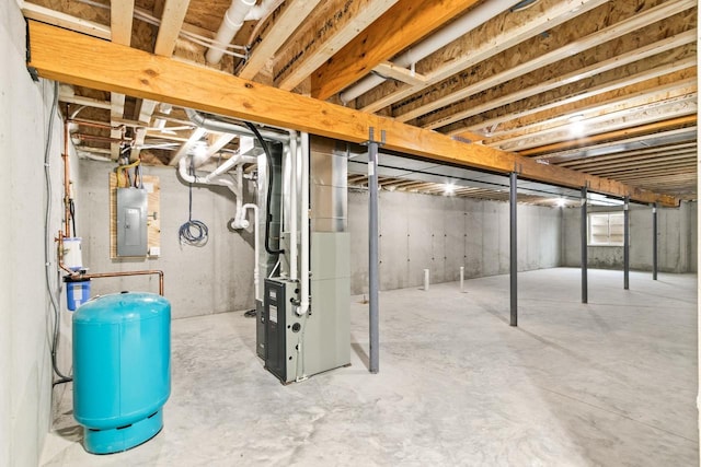 basement featuring heating unit and electric panel
