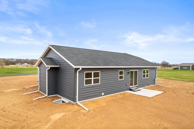 exterior space with a shingled roof and entry steps