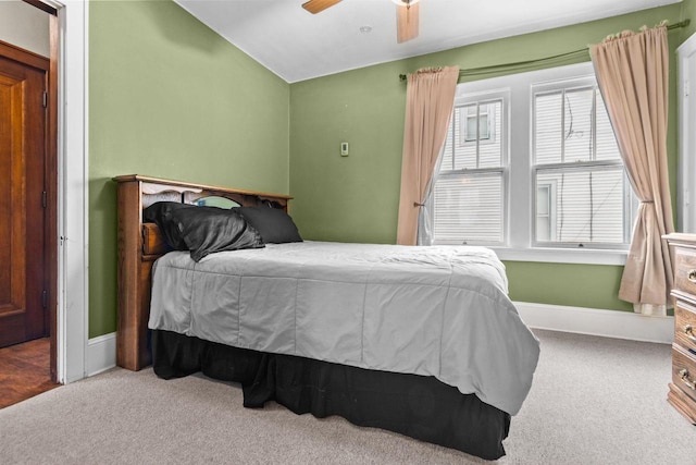 bedroom featuring carpet floors, baseboards, ceiling fan, and lofted ceiling