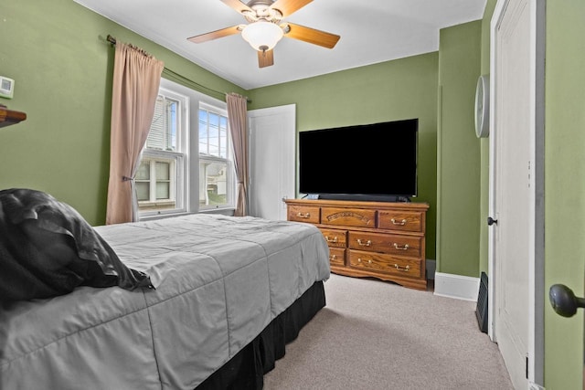 carpeted bedroom with baseboards and ceiling fan