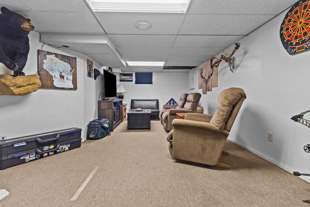 carpeted living room featuring a drop ceiling