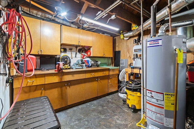 unfinished below grade area featuring a workshop area and gas water heater