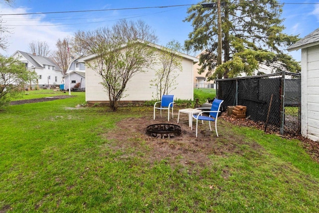view of yard featuring a fire pit and fence