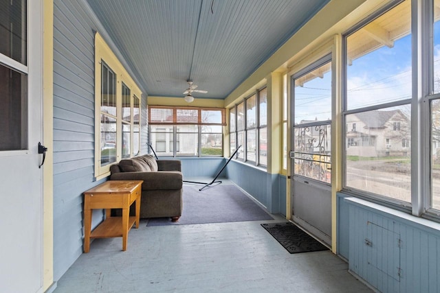 sunroom featuring a ceiling fan