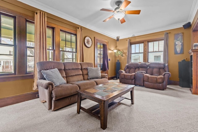 living area featuring baseboards, a ceiling fan, and ornamental molding