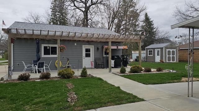 556 Gold St, Green Lake, WI 54941 - view of front of home featuring a front yard, a shed, an outdoor structure, and a patio area