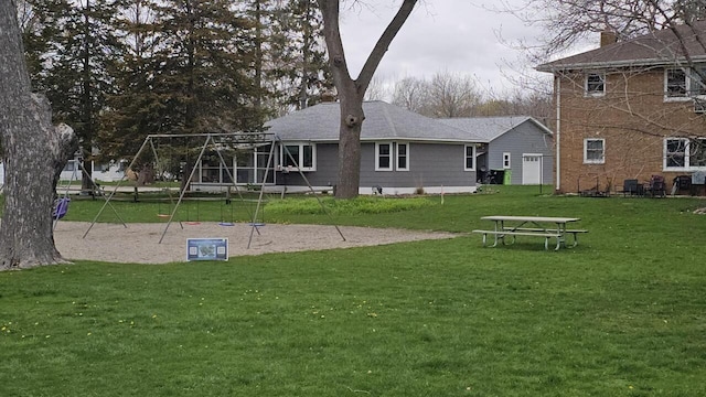 556 Gold St, Green Lake, WI 54941 - rear view of property featuring a playground and a yard