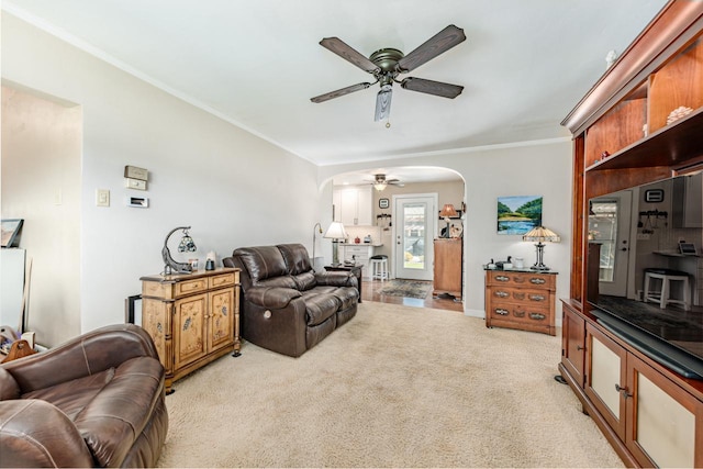 556 Gold St, Green Lake, WI 54941 - living area with arched walkways, ceiling fan, light carpet, ornamental molding, and baseboards