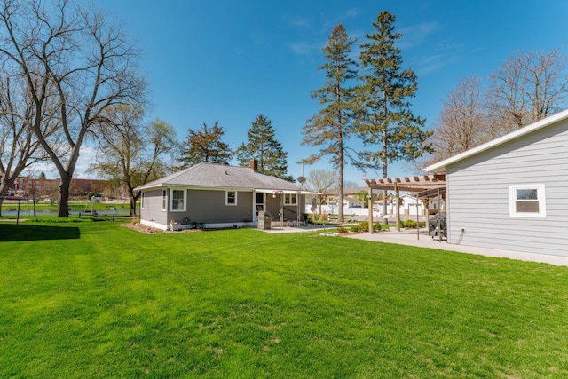 556 Gold St, Green Lake, WI 54941 - back of property with a pergola, a patio, a chimney, and a lawn