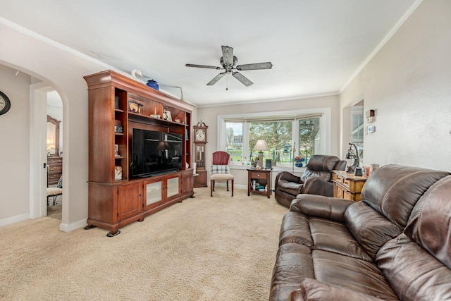 556 Gold St, Green Lake, WI 54941 - living room featuring ceiling fan, arched walkways, ornamental molding, light colored carpet, and baseboards