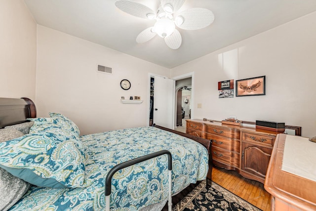 556 Gold St, Green Lake, WI 54941 - bedroom featuring light wood-style flooring, ceiling fan, and arched walkways