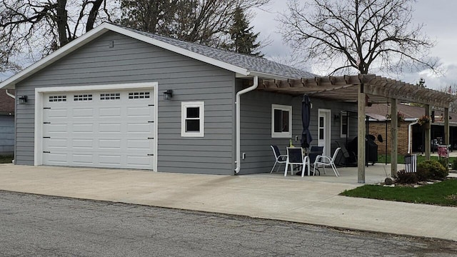 556 Gold St, Green Lake, WI 54941 - view of front of home with a pergola, driveway, and a detached garage