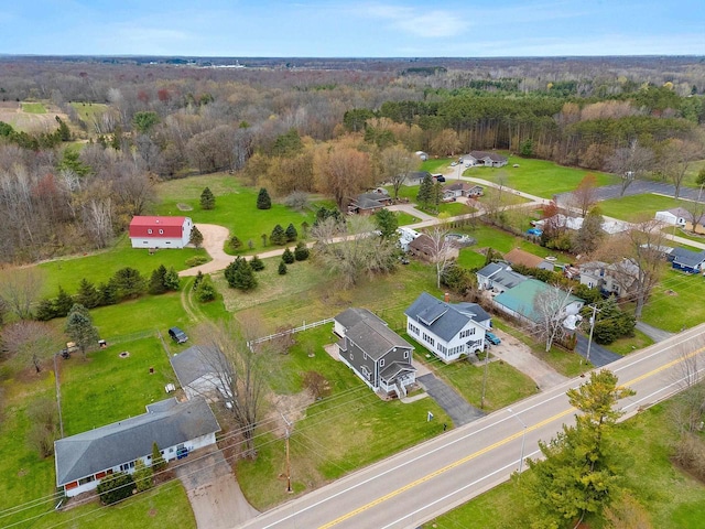 drone / aerial view featuring a wooded view