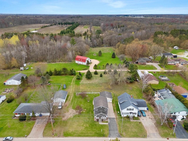 bird's eye view featuring a forest view and a residential view
