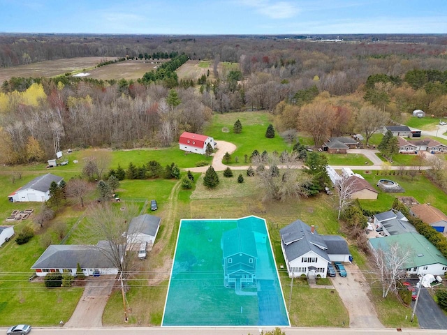 birds eye view of property featuring a wooded view