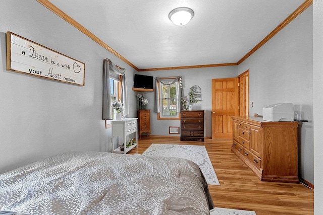 bedroom with light wood-type flooring and crown molding