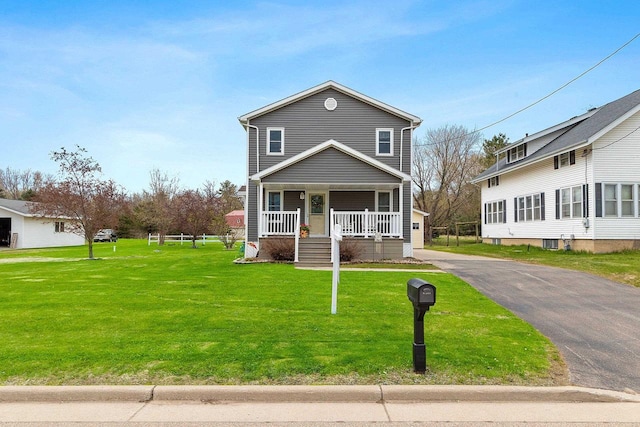 traditional home with driveway, a porch, and a front lawn