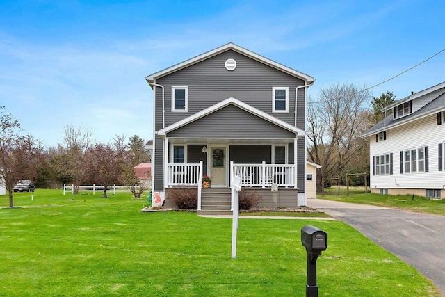 traditional home with a porch and a front lawn