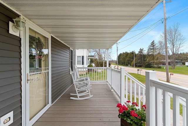 wooden terrace featuring covered porch