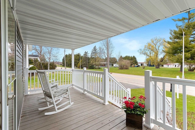 deck with covered porch and a lawn