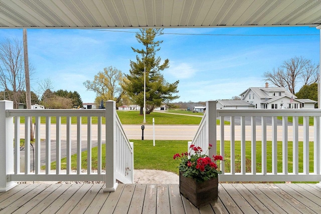 deck featuring a yard and a residential view
