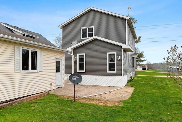rear view of house with a yard and a patio area
