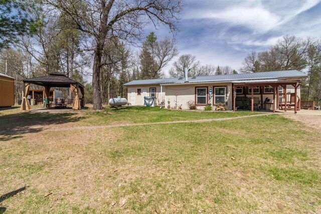 976 Blackhawk Ct, Hancock, WI 54943 - back of house featuring a gazebo, a yard, and metal roof