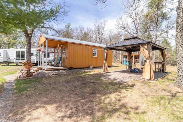 976 Blackhawk Ct, Hancock, WI 54943 - rear view of house featuring a wooden deck, a gazebo, and metal roof
