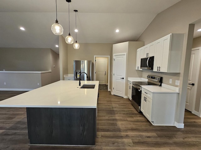 kitchen featuring dark wood-style flooring, appliances with stainless steel finishes, vaulted ceiling, a sink, and light countertops
