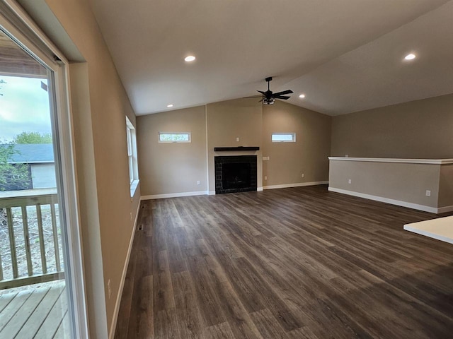unfurnished living room featuring vaulted ceiling, a ceiling fan, and dark wood-type flooring