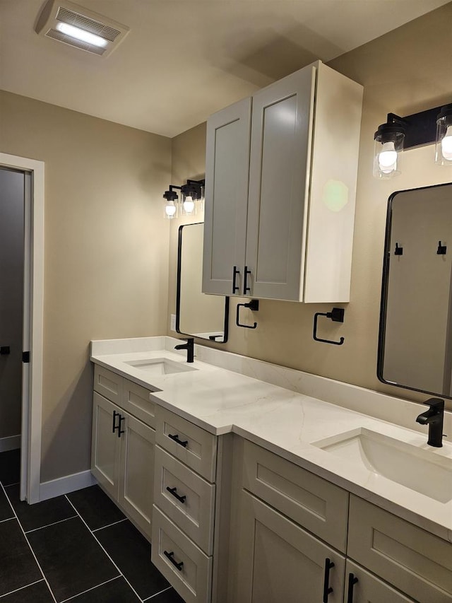 full bathroom with visible vents, double vanity, a sink, and tile patterned floors