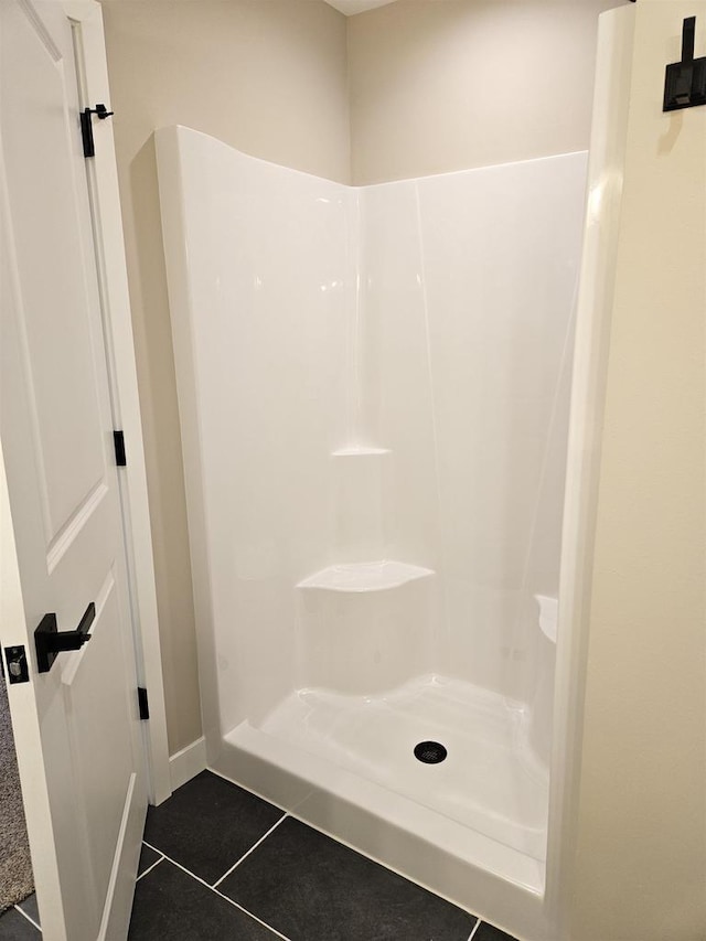 full bathroom featuring tile patterned flooring and walk in shower