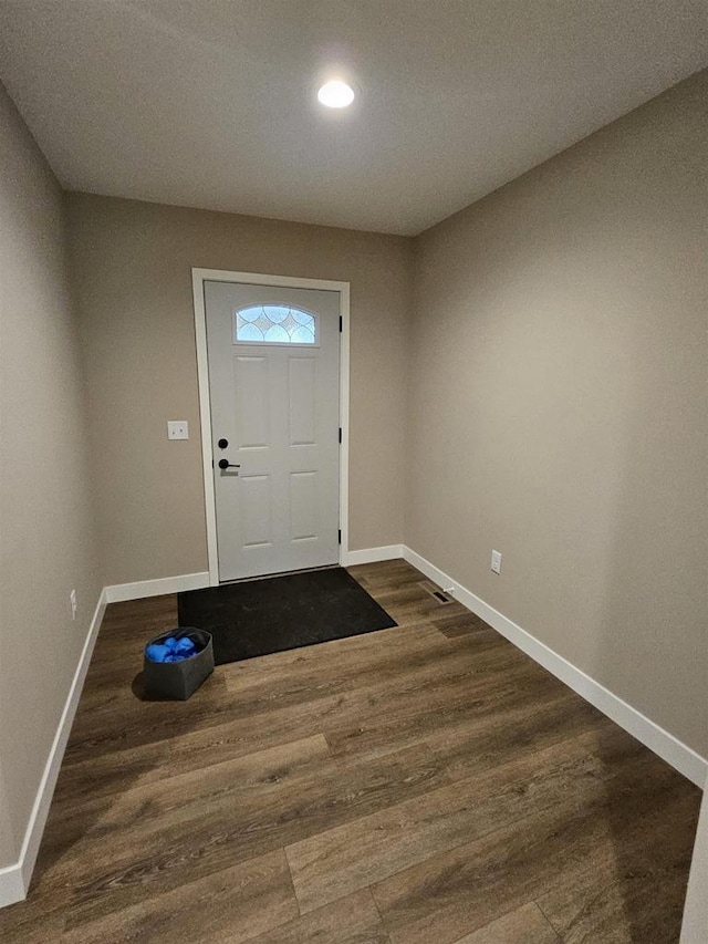 doorway featuring recessed lighting, baseboards, and dark wood-style floors