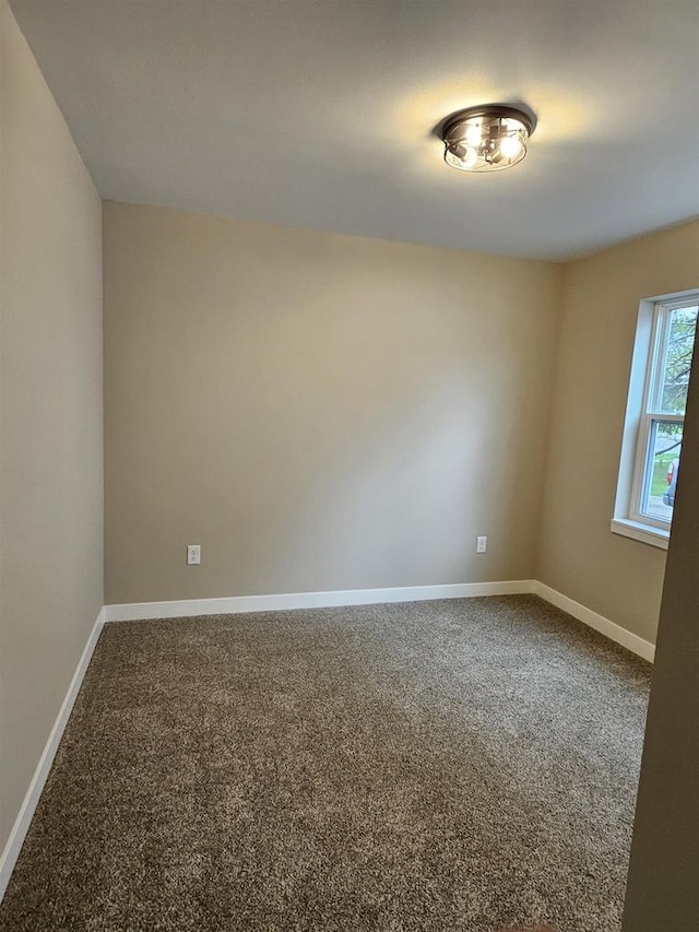 spare room with carpet floors and baseboards