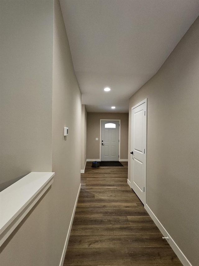 hall with baseboards, recessed lighting, and dark wood-style floors