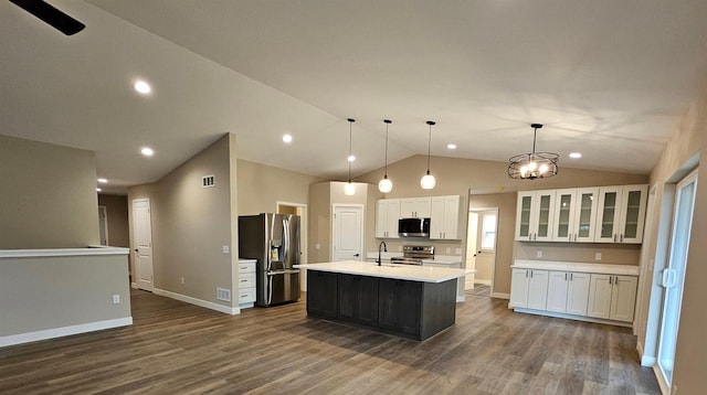 kitchen with a sink, light countertops, white cabinets, dark wood-style floors, and stainless steel appliances