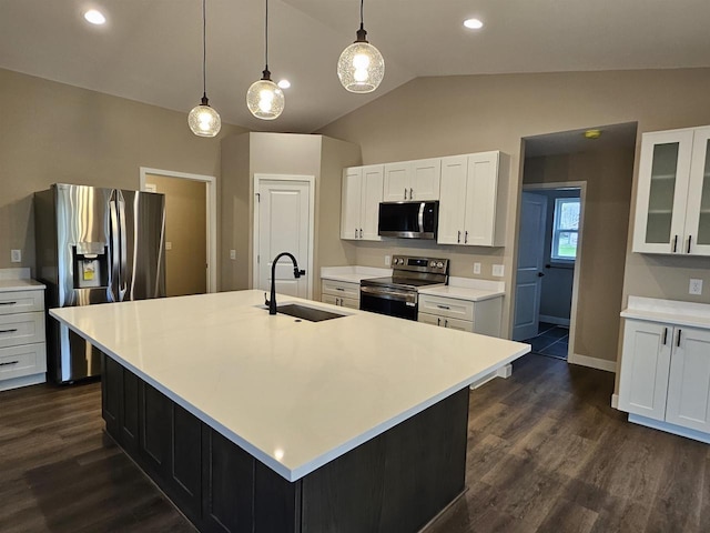 kitchen featuring lofted ceiling, light countertops, a sink, dark wood finished floors, and stainless steel appliances