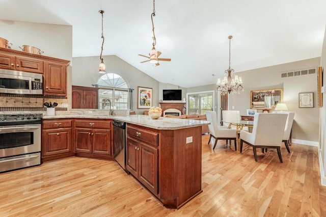 kitchen with visible vents, light wood-style floors, a peninsula, and stainless steel appliances