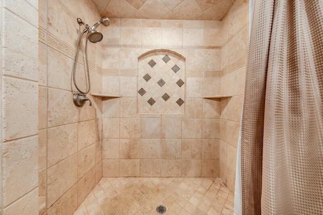 bathroom with tiled shower
