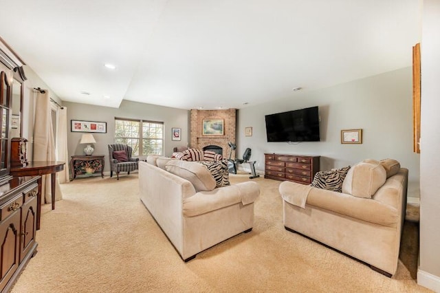 living room featuring recessed lighting, light carpet, and a fireplace