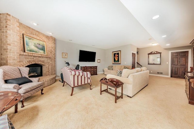 living area featuring visible vents, a fireplace, light carpet, baseboards, and recessed lighting
