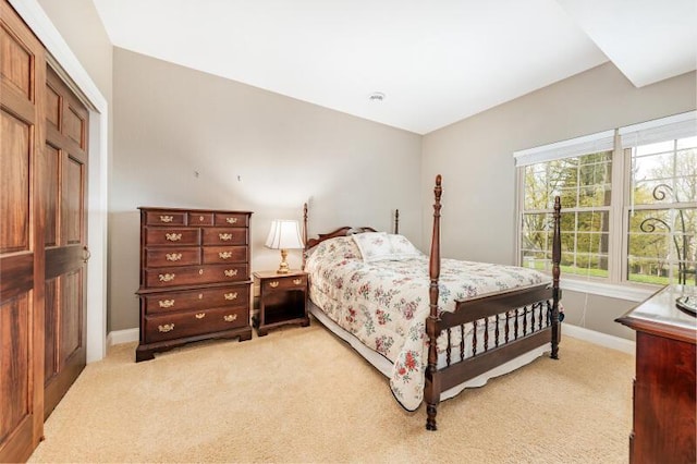 bedroom featuring baseboards and light colored carpet